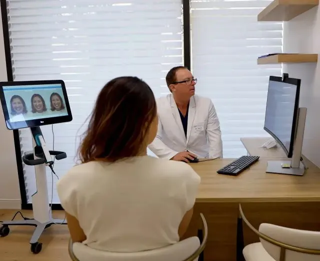 Dr. Aaron Rondon discussing Invisalign treatment results with a patient during a free consultation at Livermore Outlets Orthodontics